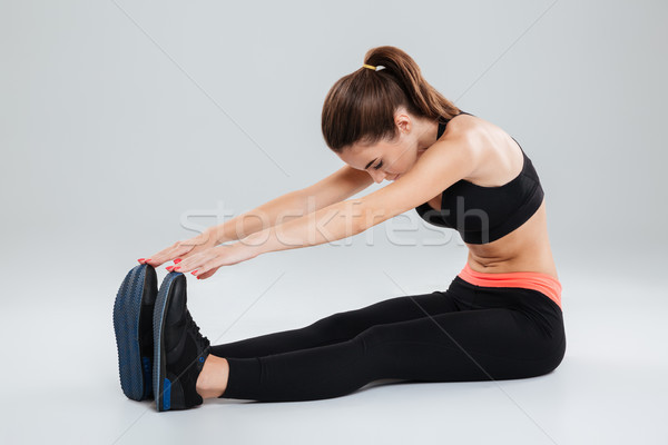 Side view of fitness woman warming up Stock photo © deandrobot