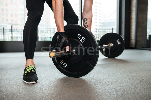 Sportsman make sport exercises in gym Stock photo © deandrobot