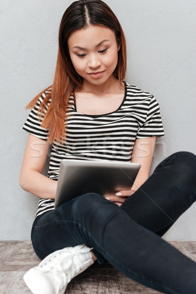 Hardworking woman working with tablet Stock photo © deandrobot