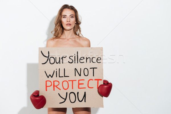 Young Naked woman in boxing gloves holding broadsheet Stock photo © deandrobot