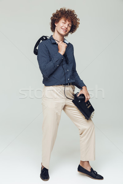 Handsome retro man holding telephone in hands. Stock photo © deandrobot