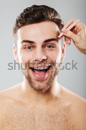 Beauty portrait of sensual brunette woman with hair in bun screa Stock photo © deandrobot