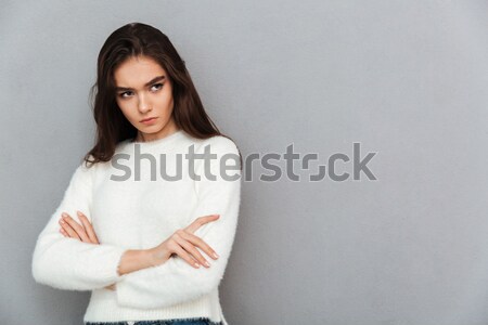 Close-up photo of upset brunette girl in soft sweater standing w Stock photo © deandrobot