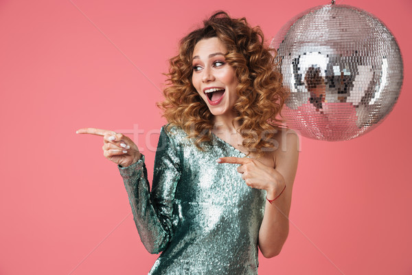 Portrait of a happy beautiful woman in shiny dress Stock photo © deandrobot