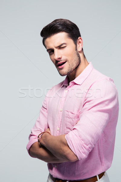 Young businessman standing with arms folded Stock photo © deandrobot