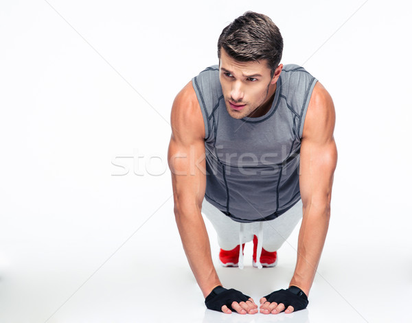 Fitness młody człowiek pompek odizolowany biały Zdjęcia stock © deandrobot