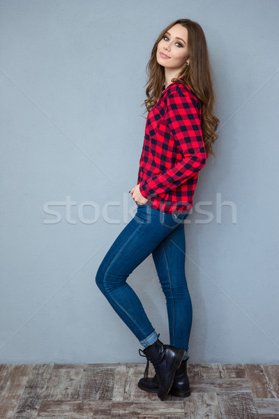 Full length portrait of a casual pretty woman Stock photo © deandrobot