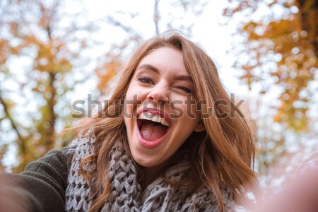 Woman making selfie photo in autumn park  Stock photo © deandrobot