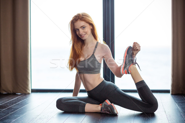 Fitness redhair woman stretching legs  Stock photo © deandrobot