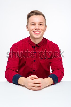 Pozitif genç erkek oturma bakıyor Stok fotoğraf © deandrobot