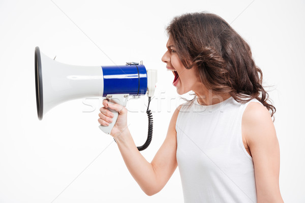 Woman screaming into megaphone Stock photo © deandrobot