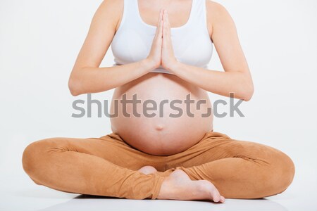 Imagem mulher grávida meditando isolado branco esportes Foto stock © deandrobot