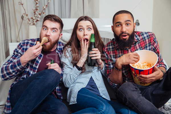 Frightened shocked people drinking beer and watching tv Stock photo © deandrobot