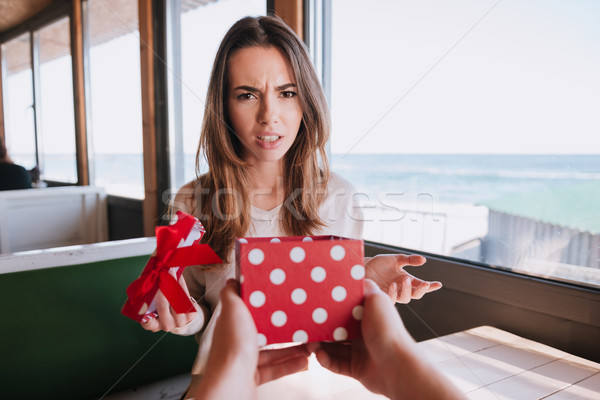 Displeased woman gets the gift Stock photo © deandrobot