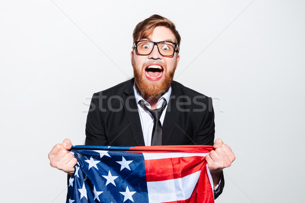 Screaming business man with flag Stock photo © deandrobot
