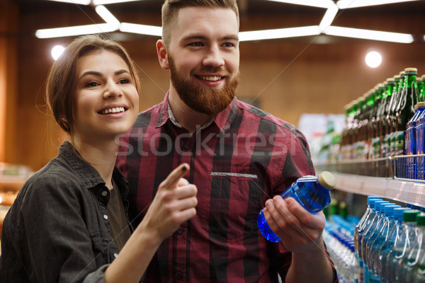 Fiatal boldog szerető pár áruház választ Stock fotó © deandrobot