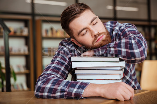 Fáradt fiatalember tart fej könyv boglya Stock fotó © deandrobot