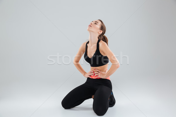 Müde Fitness Frau Sitzung Stock Hände hip Stock foto © deandrobot