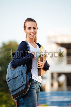 Retrato alegre estudante menina em pé mochila Foto stock © deandrobot