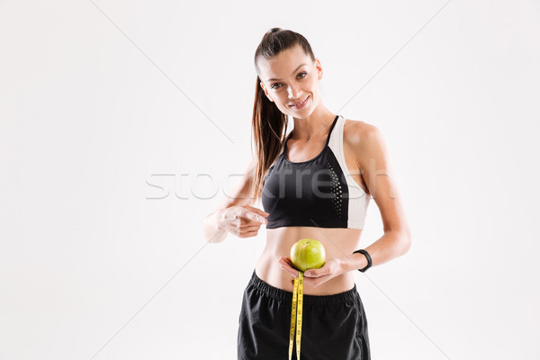 Porträt lächelnd jungen Fitness Frau halten grünen Stock foto © deandrobot