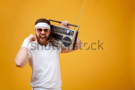 Portrait of a smiling young girl holding record player Stock photo © deandrobot