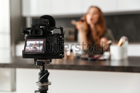 Smiling healthy young girl recording her video blog episode Stock photo © deandrobot