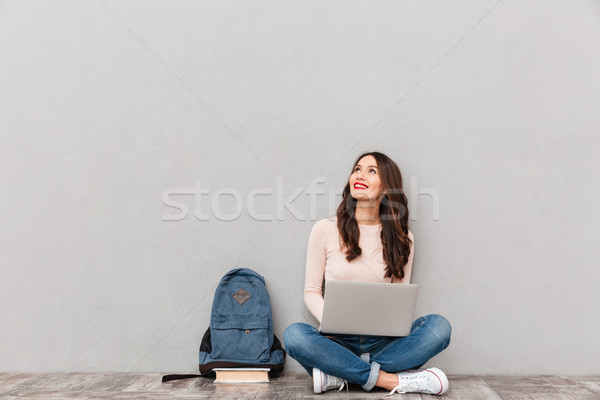 Horizontal image of female looking upward while reading or commu Stock photo © deandrobot