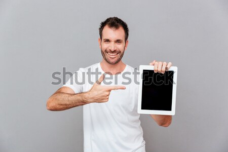 Heiter junger Mann Display Handy Bild Stock foto © deandrobot