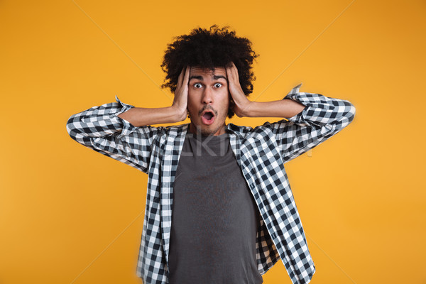 Portrait of a shocked astonished african man Stock photo © deandrobot