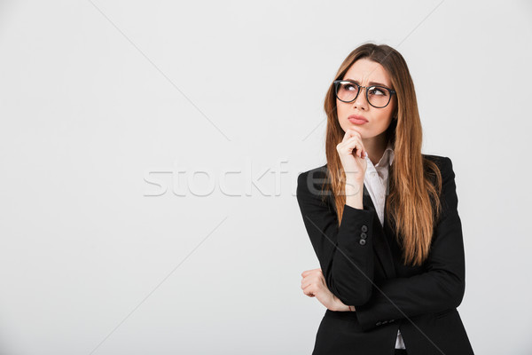 Portrait of a thoughtful businesswoman dressed in suit Stock photo © deandrobot