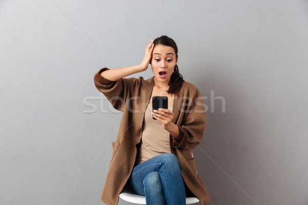 Portrait of an astonished casual asian woman Stock photo © deandrobot