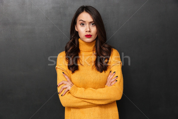 Displeased brunette woman in sweater with crossed arms Stock photo © deandrobot