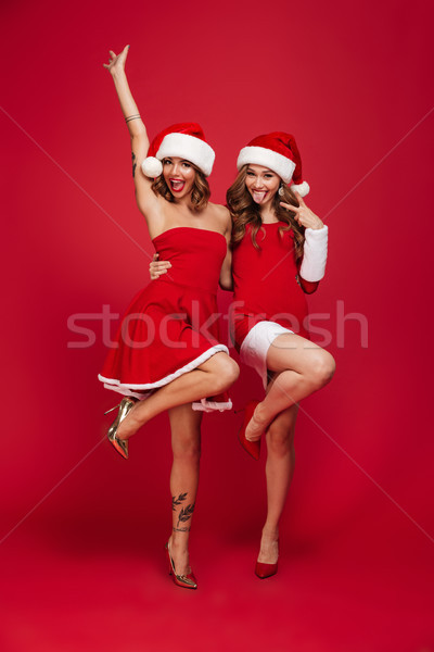 Full length portrait of two cheery laughing girls Stock photo © deandrobot