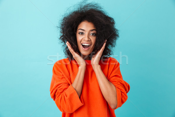 Colorful portrait of excited woman in red shirt looking on camer Stock photo © deandrobot