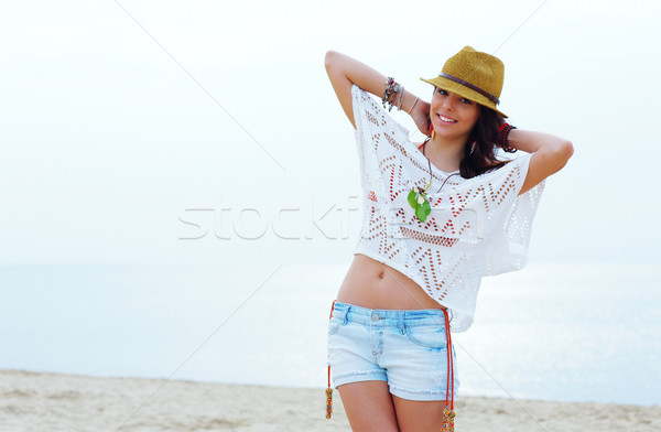 Young woman in stylish outfit walking on the the beach Stock photo © deandrobot