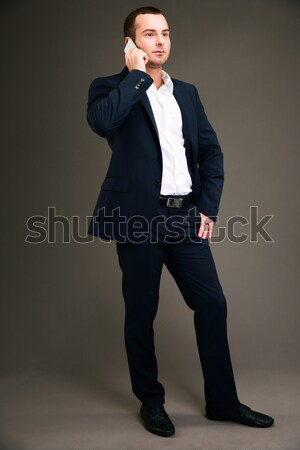 Full length portrait of pensive businessman talking on the phone Stock photo © deandrobot