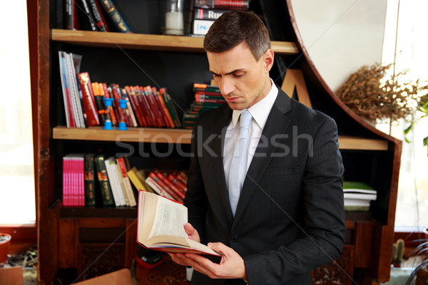 Businessman reading the book Stock photo © deandrobot