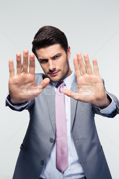 Businessman showing stop gesture Stock photo © deandrobot