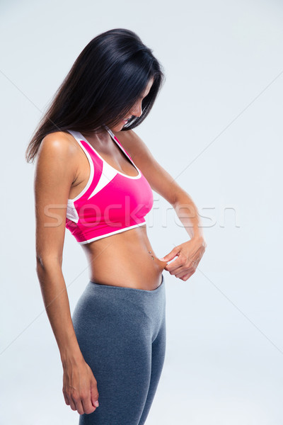 Fitnessz fiatal nő megérint has kövér szürke Stock fotó © deandrobot