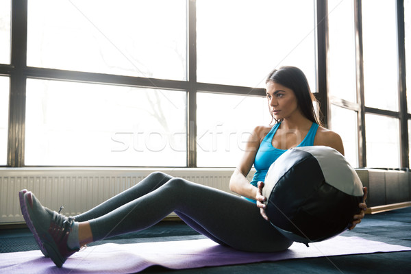 Young sports woman working out with fit ball Stock photo © deandrobot