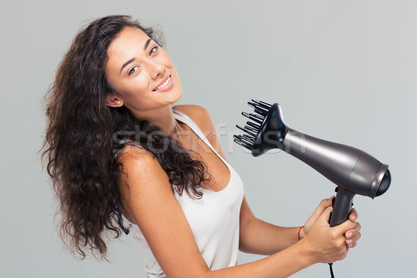 Smiling pretty woman dries her hair  Stock photo © deandrobot