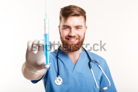 Handsome male doctor holding tube with liquid  Stock photo © deandrobot