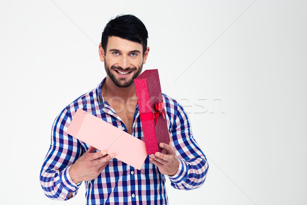Portrait of a happy man opening gift box Stock photo © deandrobot