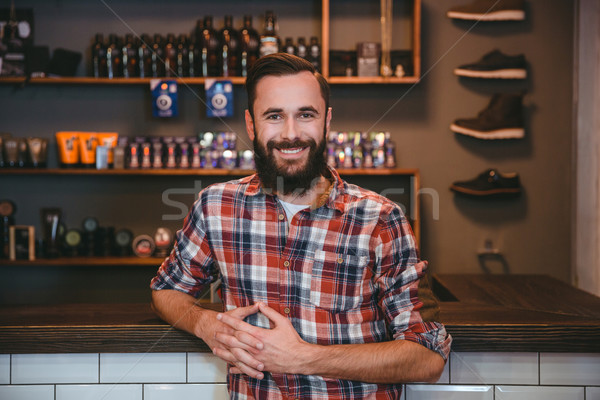 Joyful smiling bearded man posing in barbershop  Stock photo © deandrobot