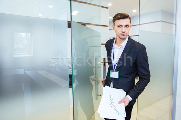 Serious business man entering the meeting room Stock photo © deandrobot