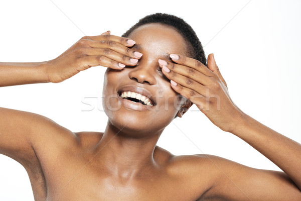 Cheerful afro american woman covering her eyes Stock photo © deandrobot