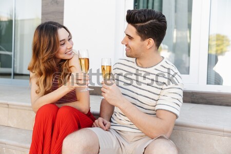 Three young happy beautiful girls in bikini drinking Stock photo © deandrobot