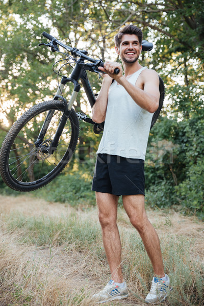 Teljes alakos kerékpáros tart bicikli erdő út Stock fotó © deandrobot
