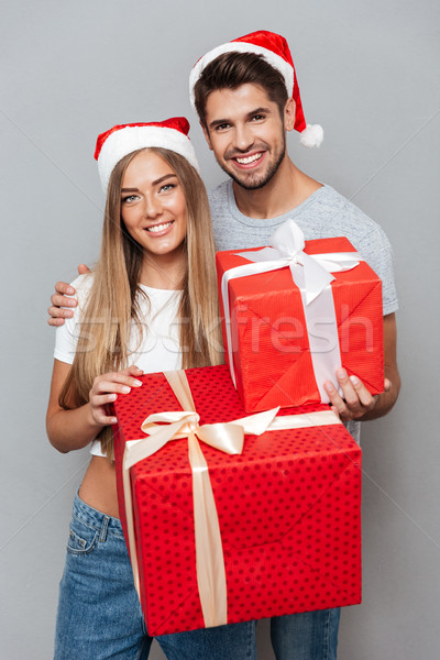 Two models with christmas surprise in hands Stock photo © deandrobot