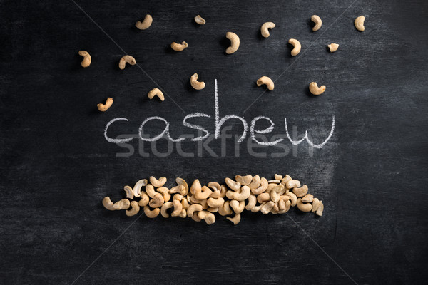 Cashew over dark chalkboard background Stock photo © deandrobot
